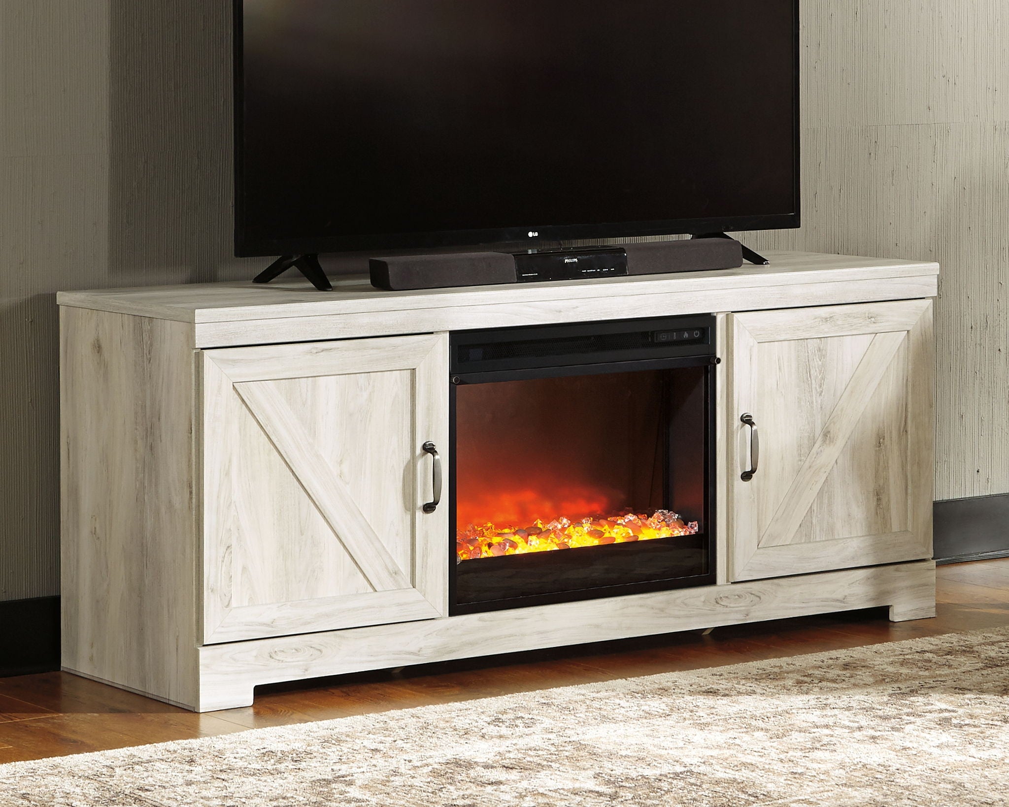 Beige TV console with two cabinet doors and built-in electric fireplace