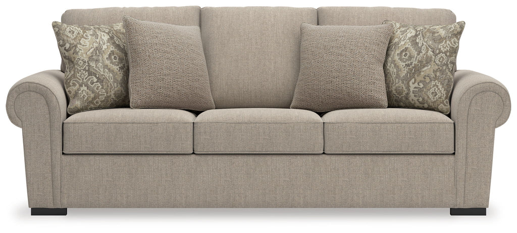 Heather fabric sofa in light beige with three front seat cushions and patterned back pillows