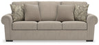 Heather fabric sofa in light beige with three front seat cushions and patterned back pillows