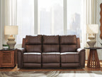 Dark brown power reclining sofa with three padded headrests and quilted seat cushions