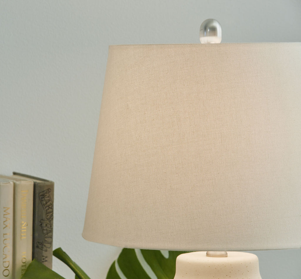 Ceramic lamp with beige fabric shade and ribbed ceramic base