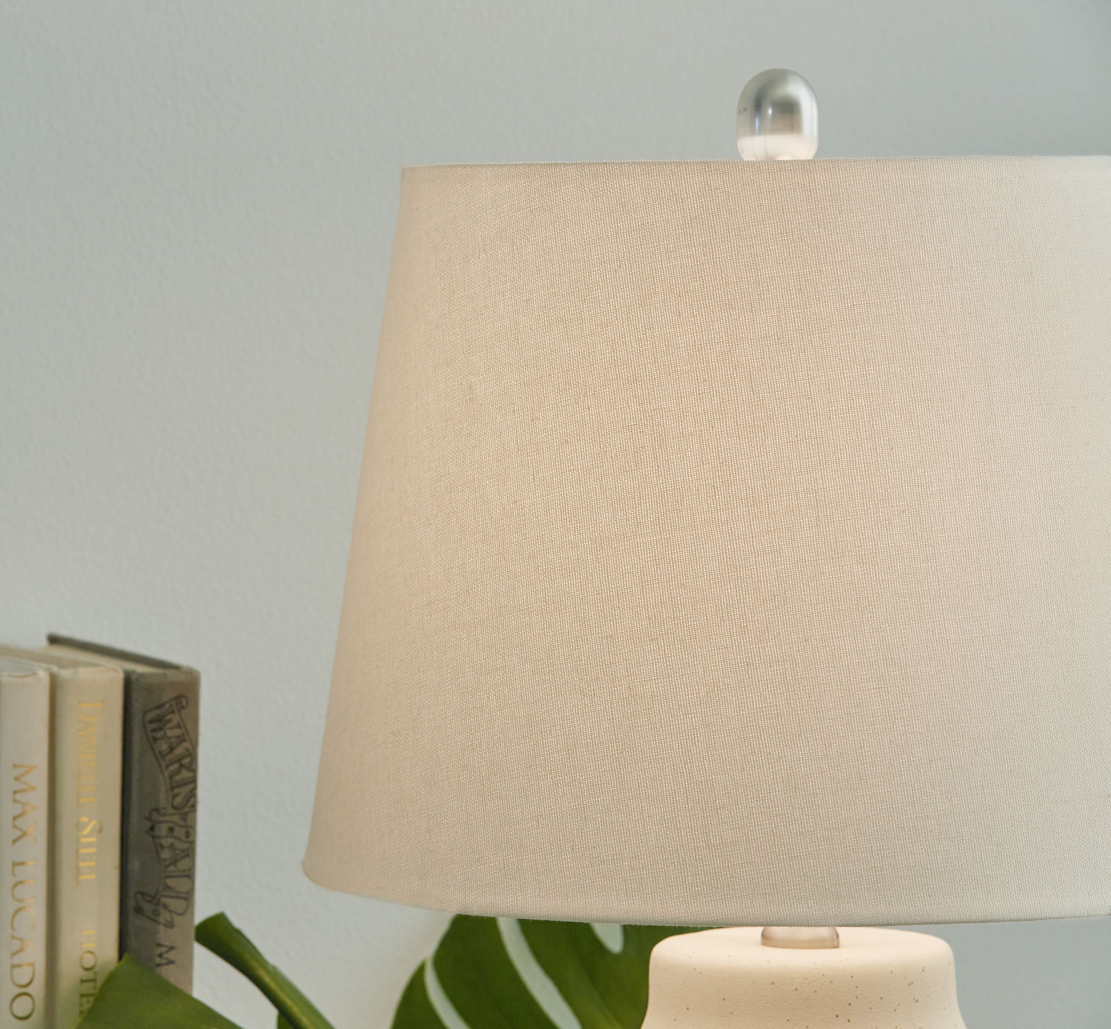 Ceramic lamp with beige fabric shade and ribbed ceramic base
