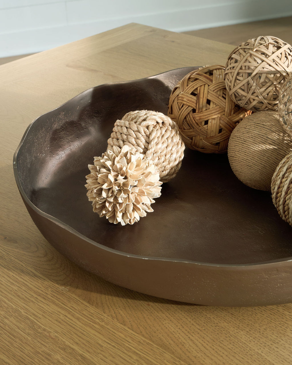 Champagne gold oval tray with rope and woven decor items