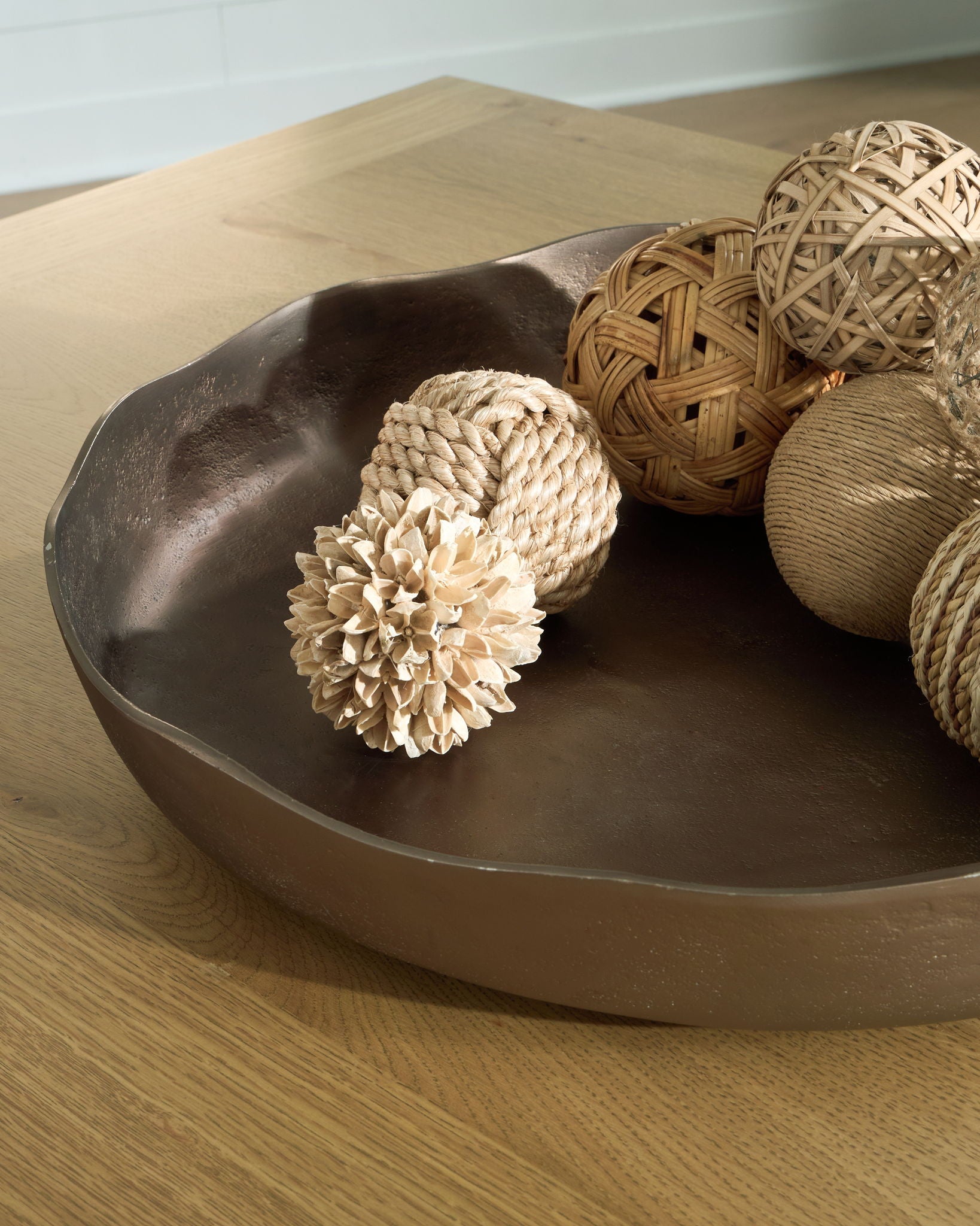 Champagne gold oval tray with rope and woven decor items