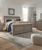 Gray panel bedroom bed with footboard and rails, styled with blue and cream bedding