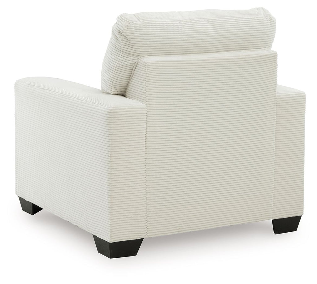 Upholstered armchair with striped fabric, rounded back, wide arms, and dark block feet.