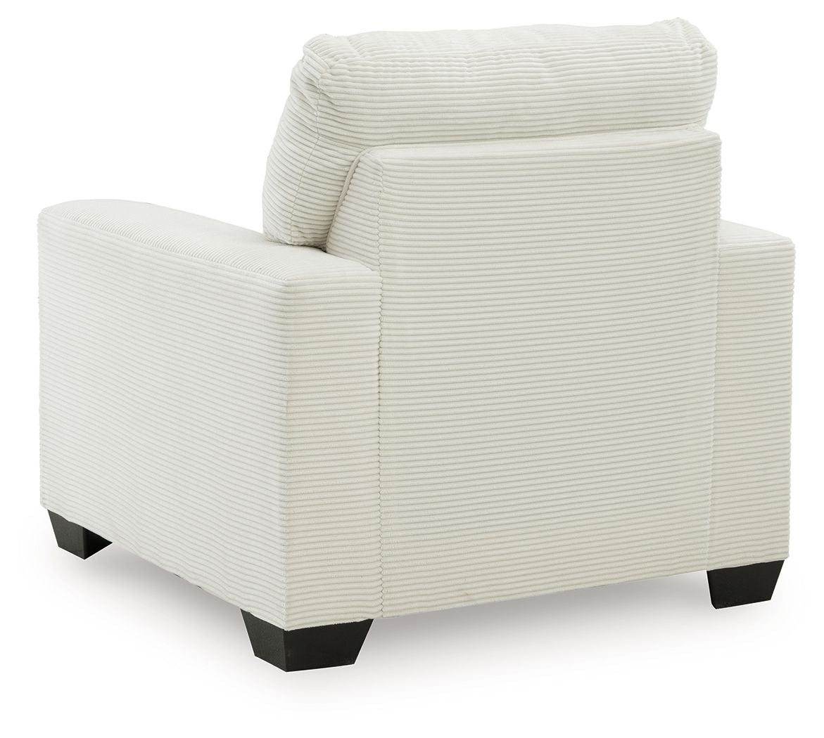 Upholstered armchair with striped fabric, rounded back, wide arms, and dark block feet.