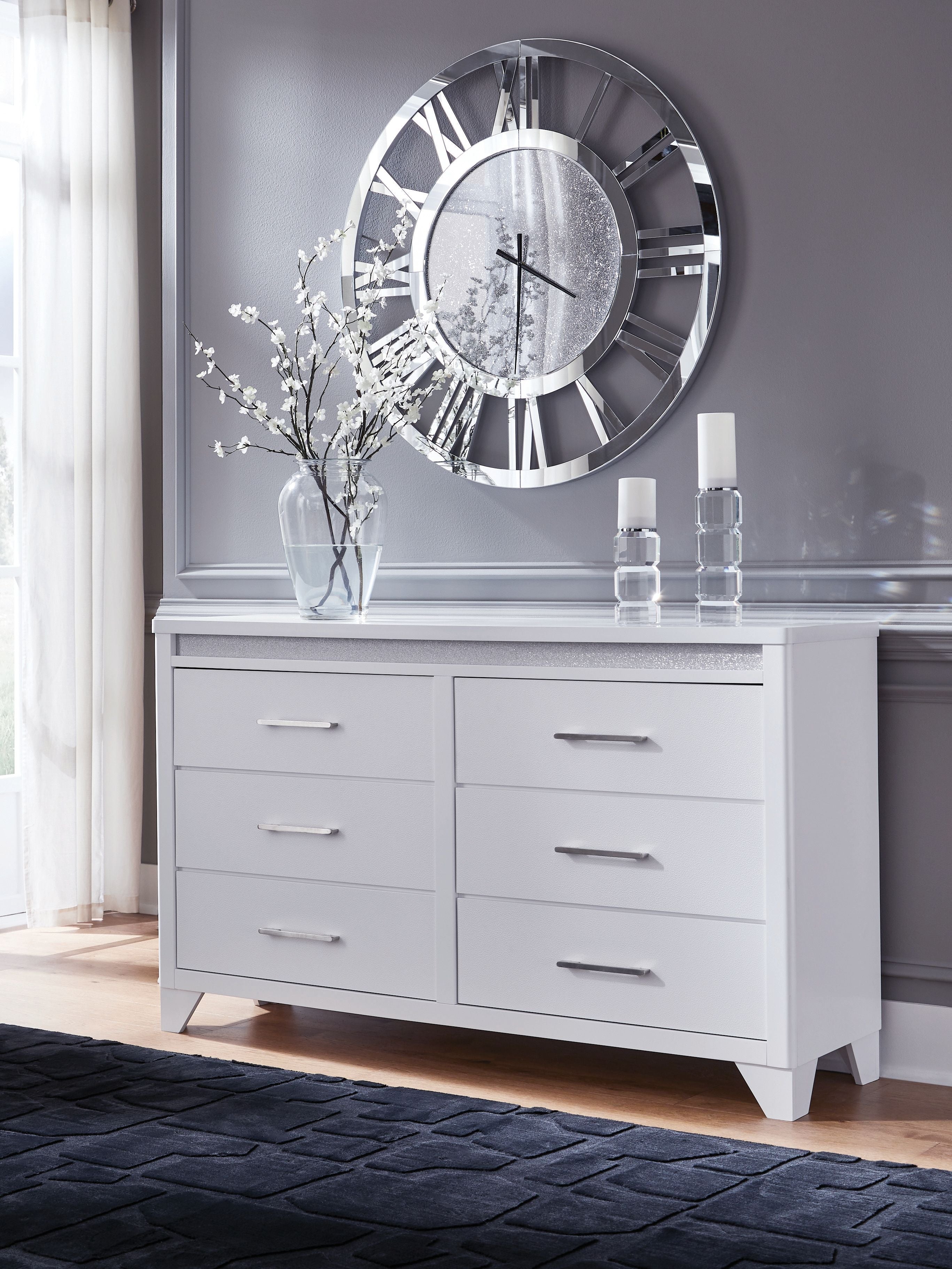 White dresser with gray textured top and six drawers with metal bar handles.