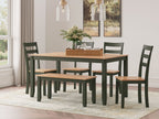Dining table with dark green chairs and dark wood tabletop