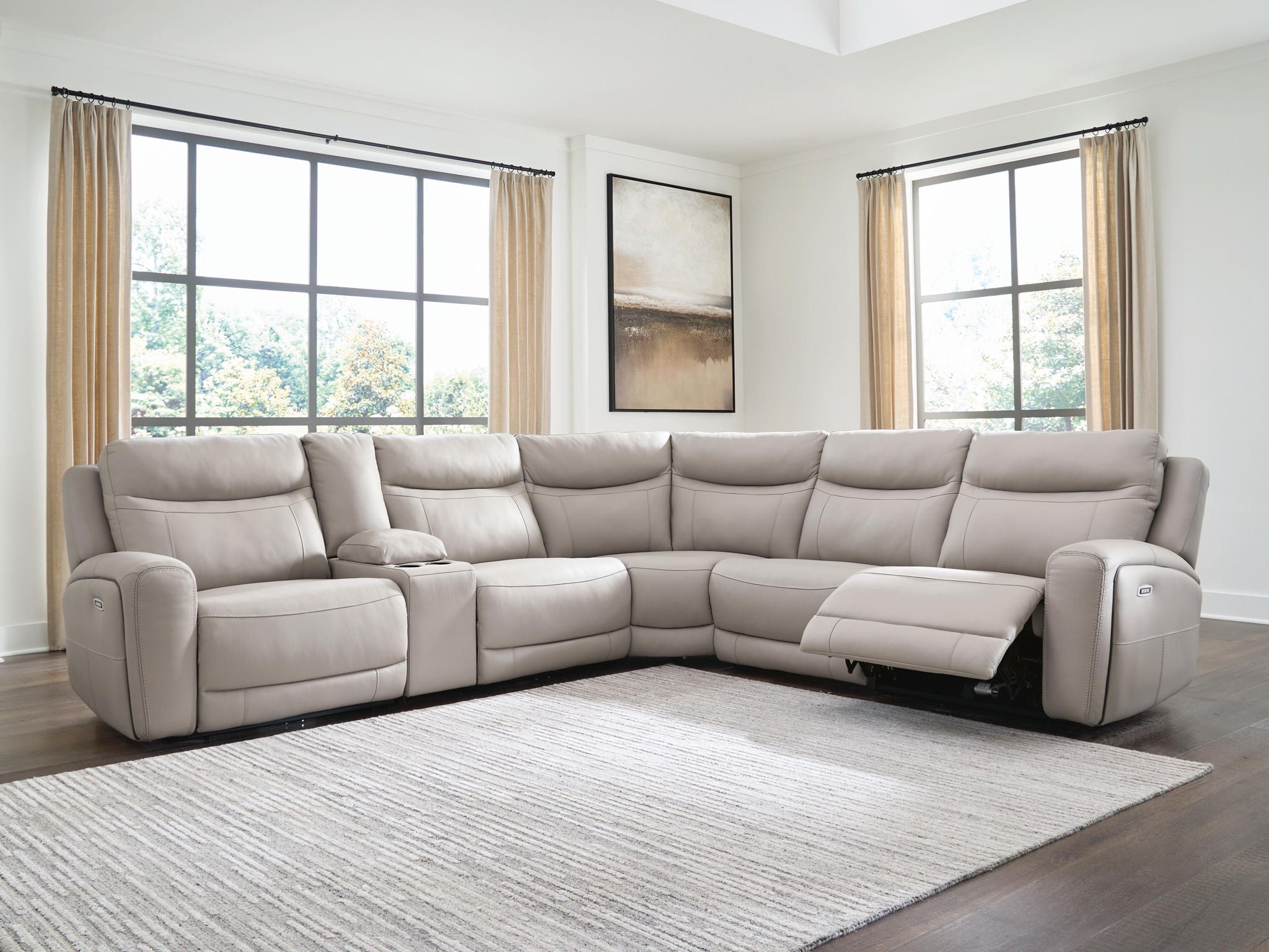 Gray power reclining sectional sofa with chaise and corner sections in a living room setting