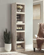 Open whitewash bookcase with four shelves, visible storage compartments