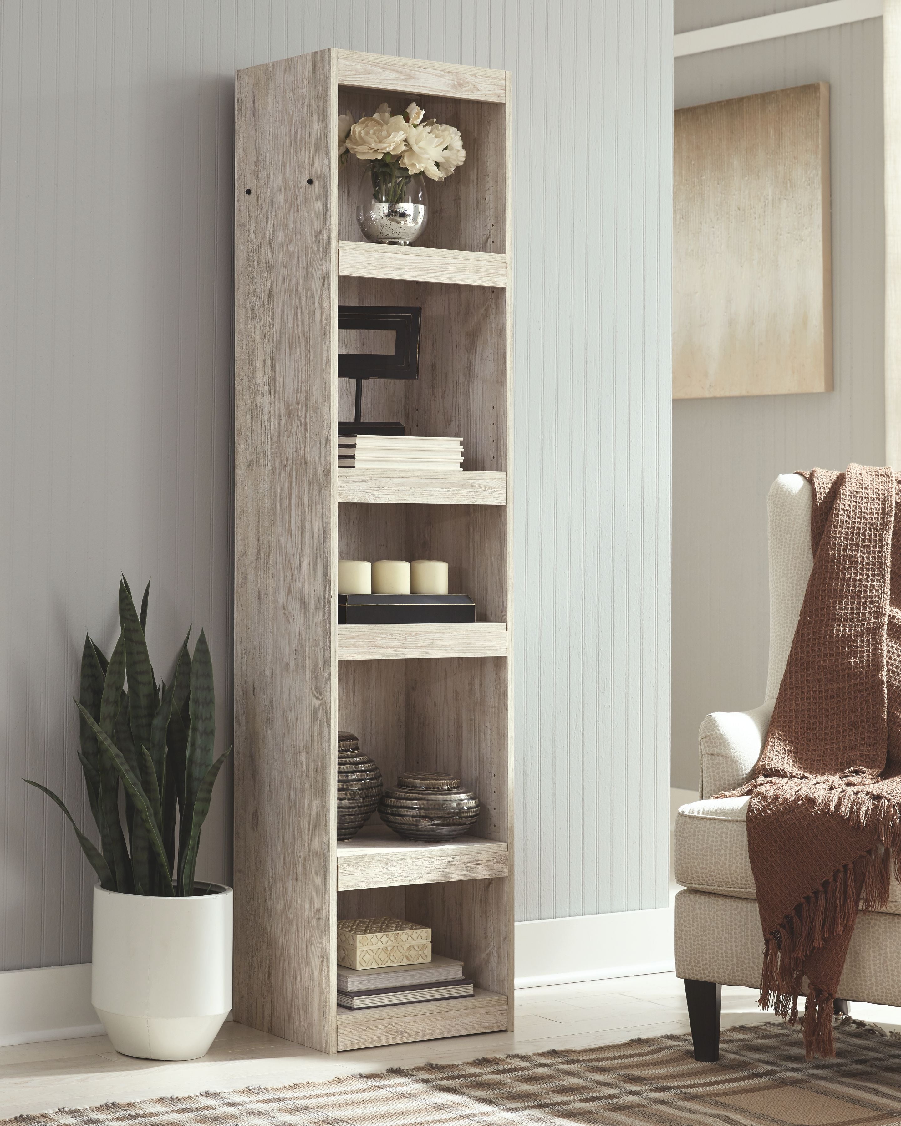 Open whitewash bookcase with four shelves, visible storage compartments