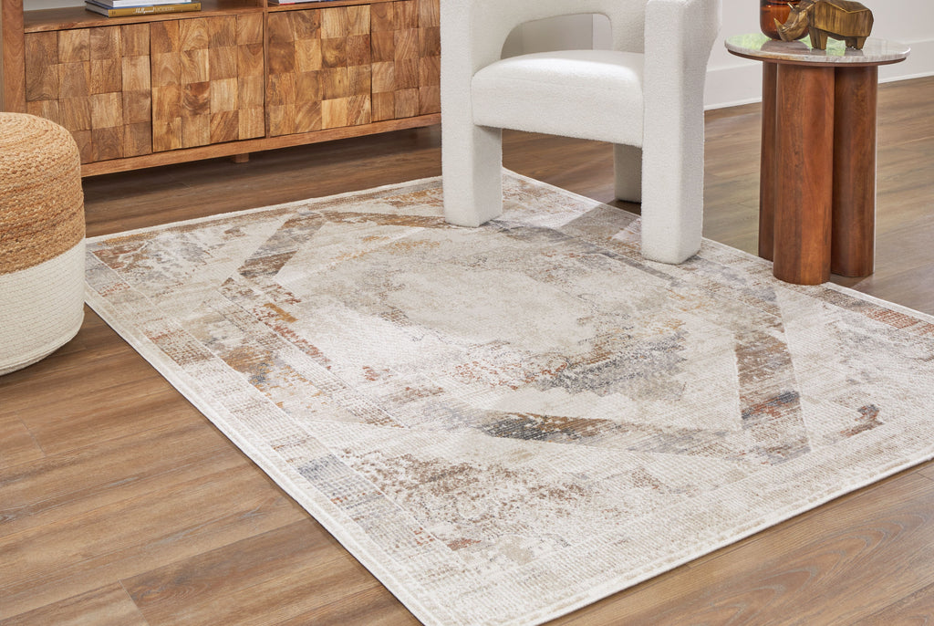 Large area rug with distressed geometric pattern in beige and gray tones.