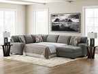 Gray sectional sleeper sofa with chaise, square arms, white bed cover, and accent pillows