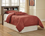Youth bookcase headboard with dark brown shelves, red quilt and pillow