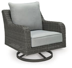 Gray swivel lounge chair with light gray seat cushion and dark woven wicker sides