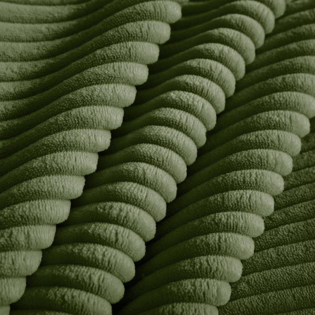 Green corduroy fabric close-up with ribbed texture