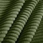 Green corduroy fabric close-up with ribbed texture