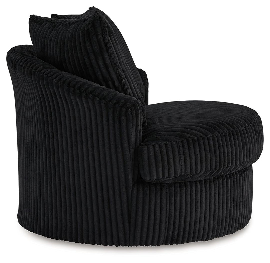 Swivel chair in dark ribbed upholstery with curved armrests and two back cushions