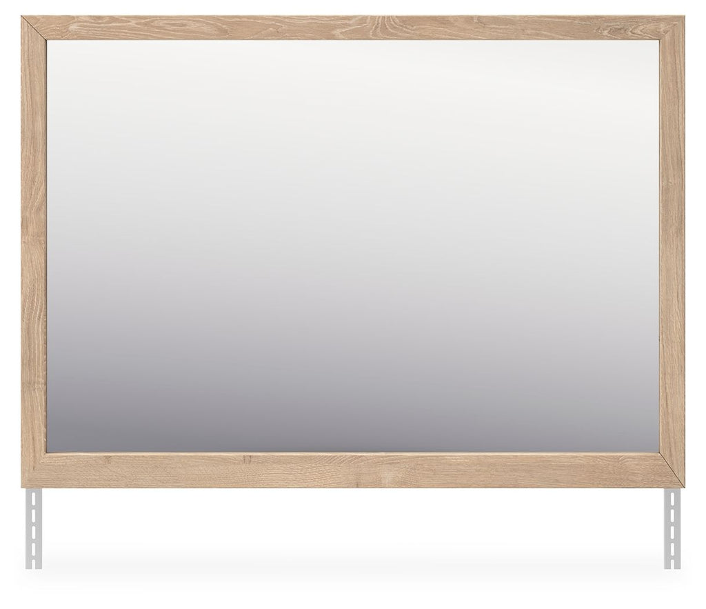 Tan wood bedroom mirror with wide beveled rectangular frame and reflective glass