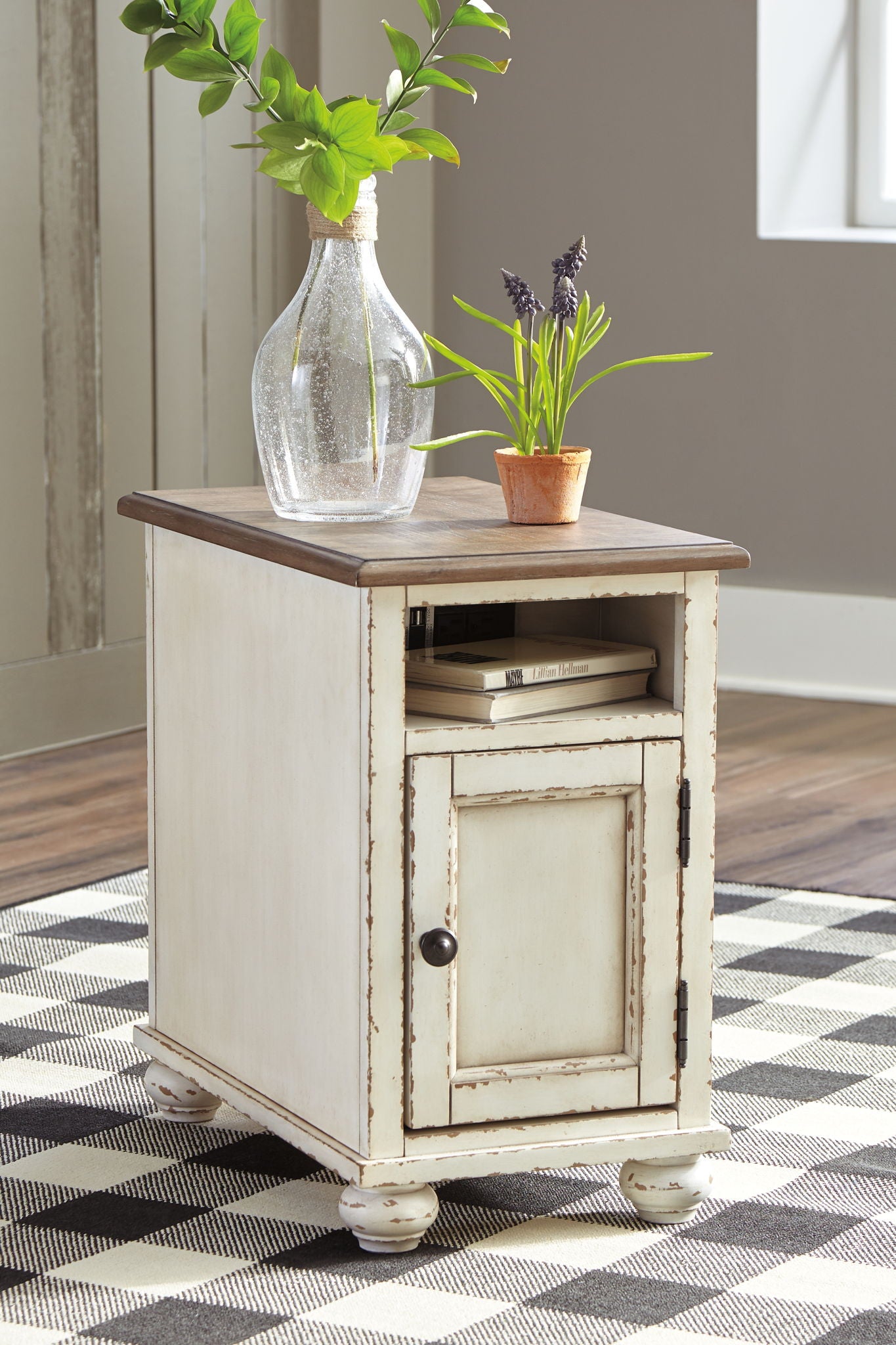White chair side end table with dark brown top, cabinet door, short turned legs
