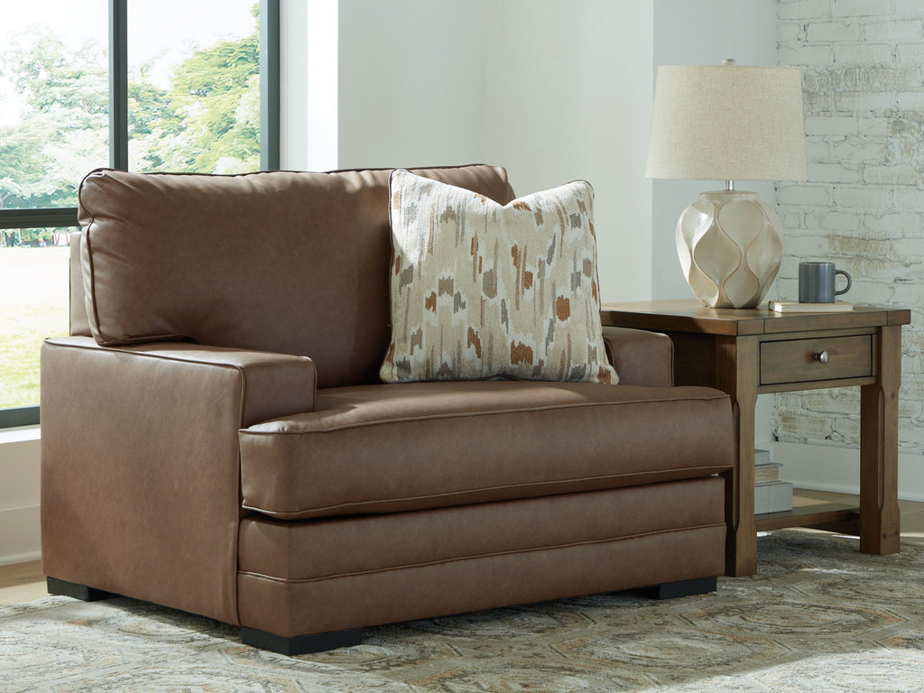 Caramel brown chair and a half with square arms and patterned throw pillow