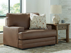 Caramel brown chair and a half with square arms and patterned throw pillow