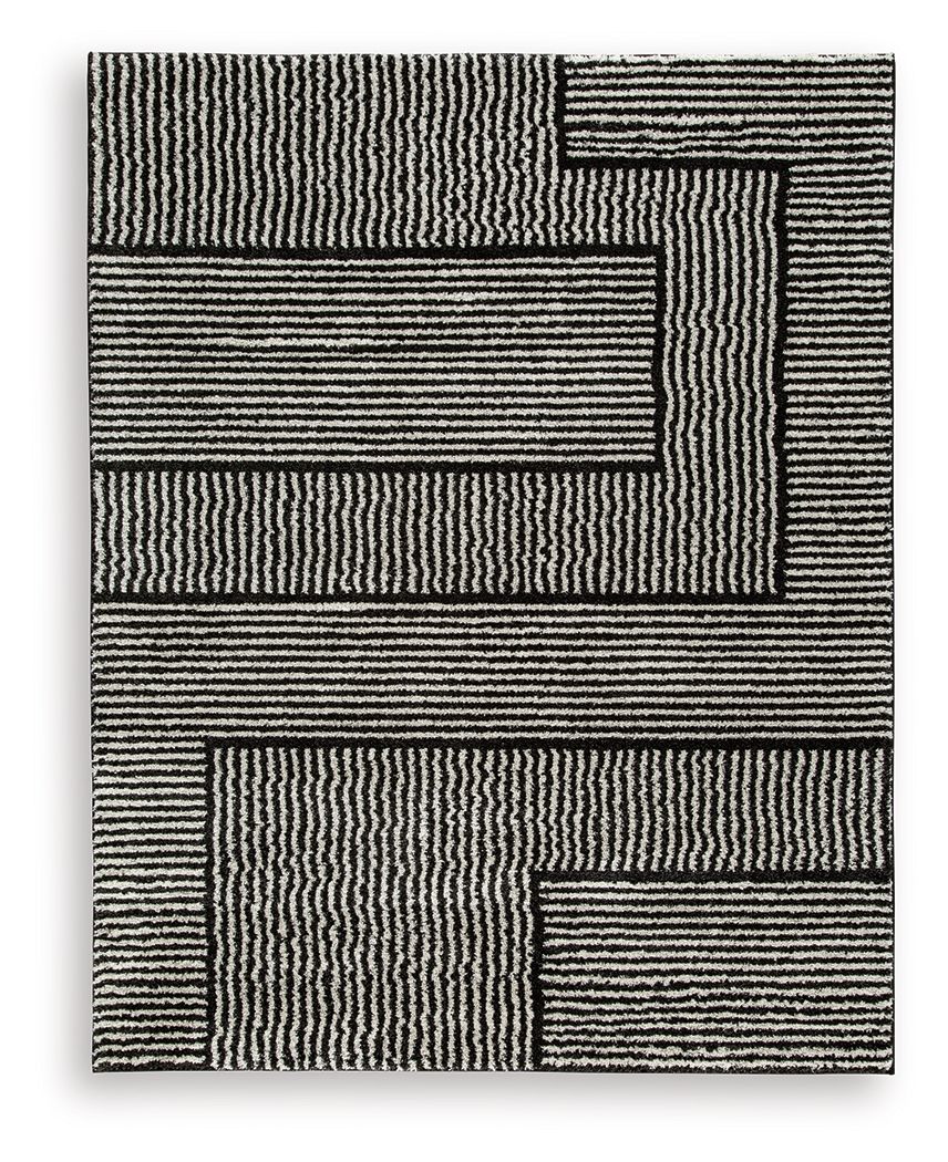 Kurtmen black rug with textured striped geometric blocks.