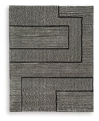 Kurtmen black rug with textured striped geometric blocks.