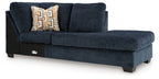 Ink blue corner chaise sofa with patterned throw pillow and dark legs