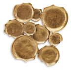 Antique gold wall decor of embossed metal leaf plaques, mixed sizes, scattered