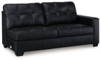 Dark carbon sofa with tufted back cushions, rolled arms, and boxy wooden legs