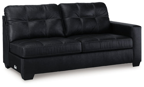 Dark carbon sofa with tufted back cushions, rolled arms, and boxy wooden legs