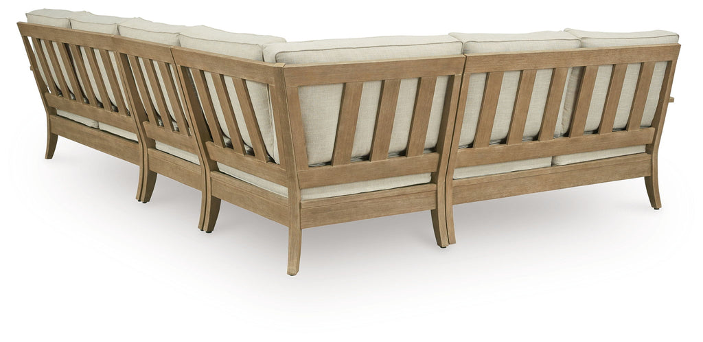 Beige outdoor sectional sofa end view with slatted wood back and arms