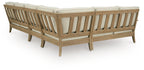 Beige outdoor sectional sofa end view with slatted wood back and arms