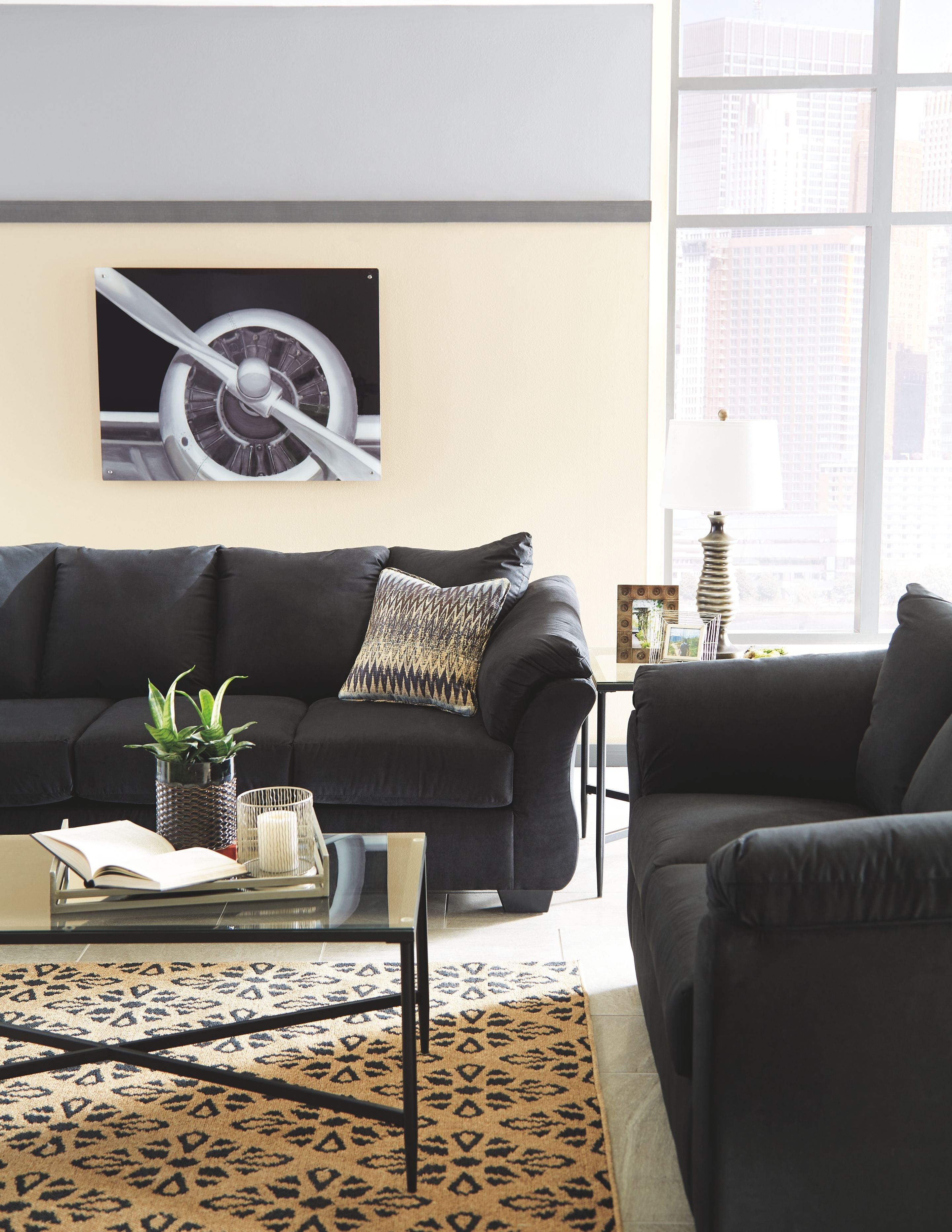 Living room set with dark sofa and loveseat, throw pillows and wide padded armrests