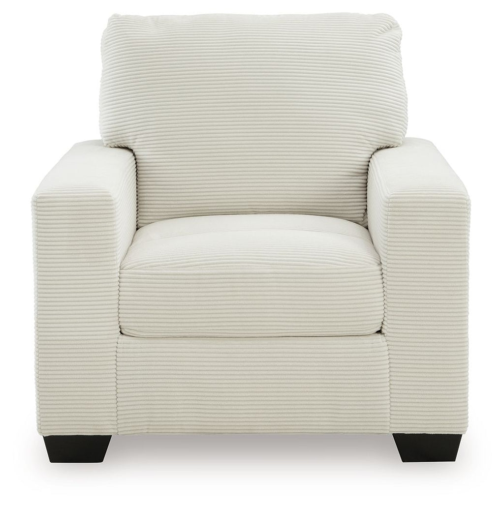 Upholstered armchair with striped fabric, cushioned seat, rolled back, and dark block legs.