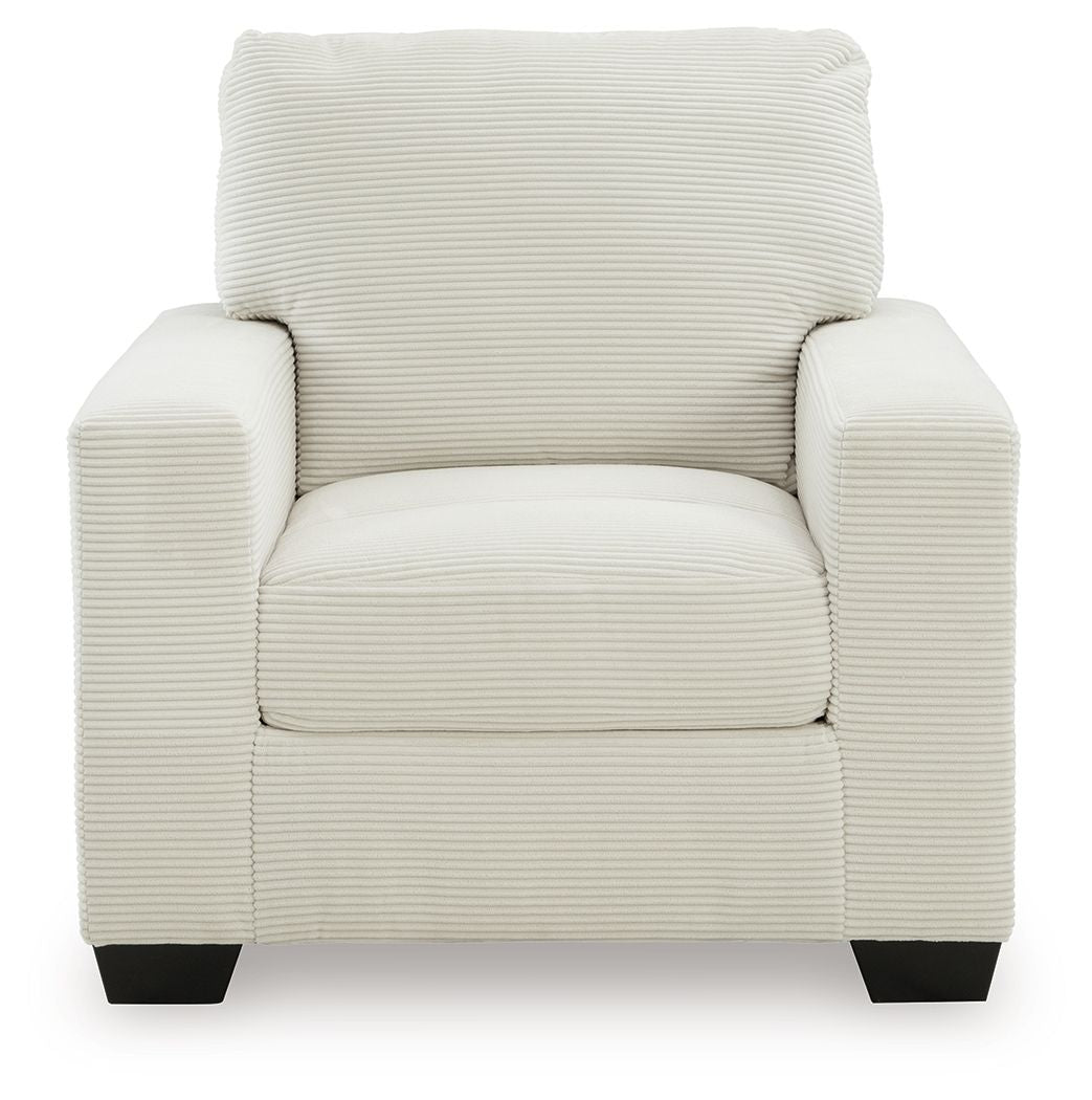 Upholstered armchair with striped fabric, cushioned seat, rolled back, and dark block legs.