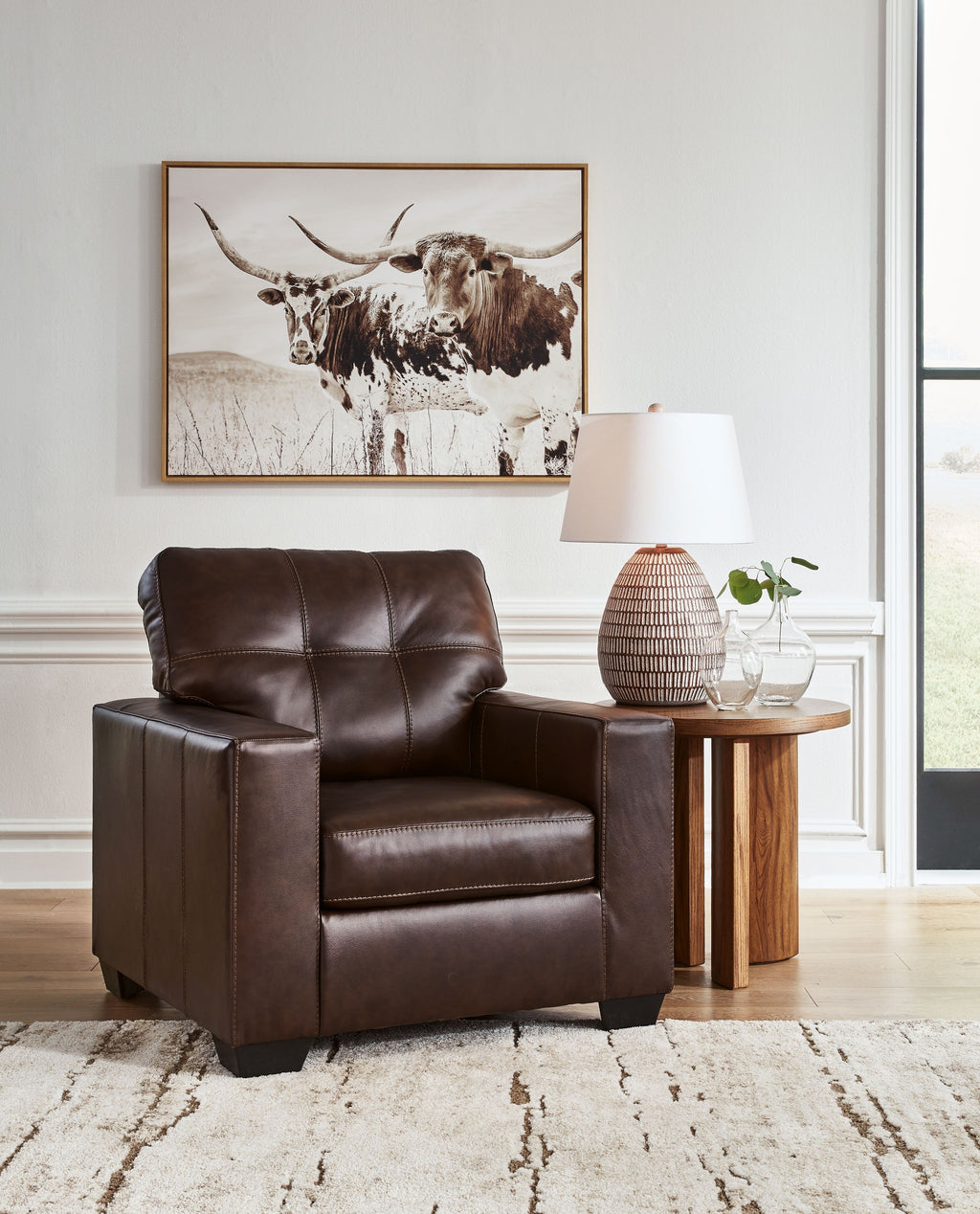 Dark brown leather accent chair with tufted back and wide padded armrests