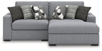 Sectional sofa with chaise in light gray, with two patterned throw pillows