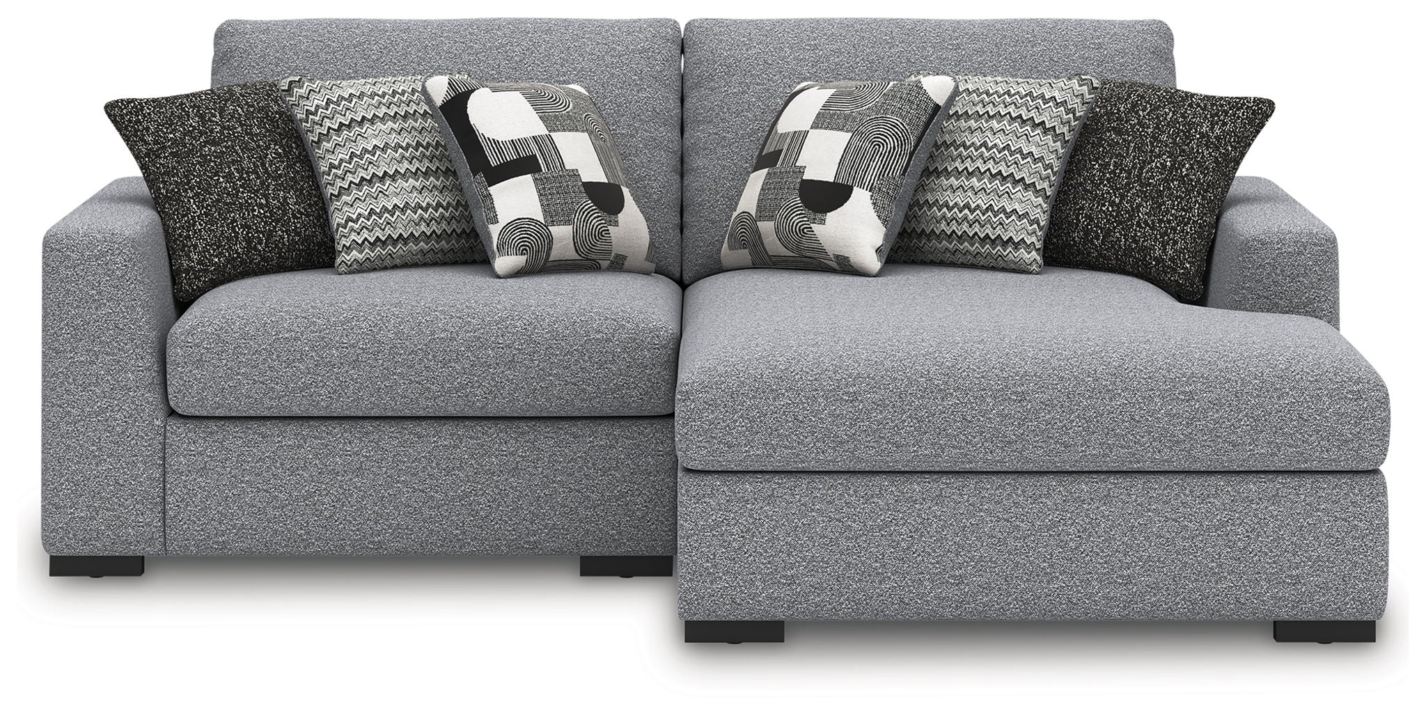 Sectional sofa with chaise in light gray, with two patterned throw pillows