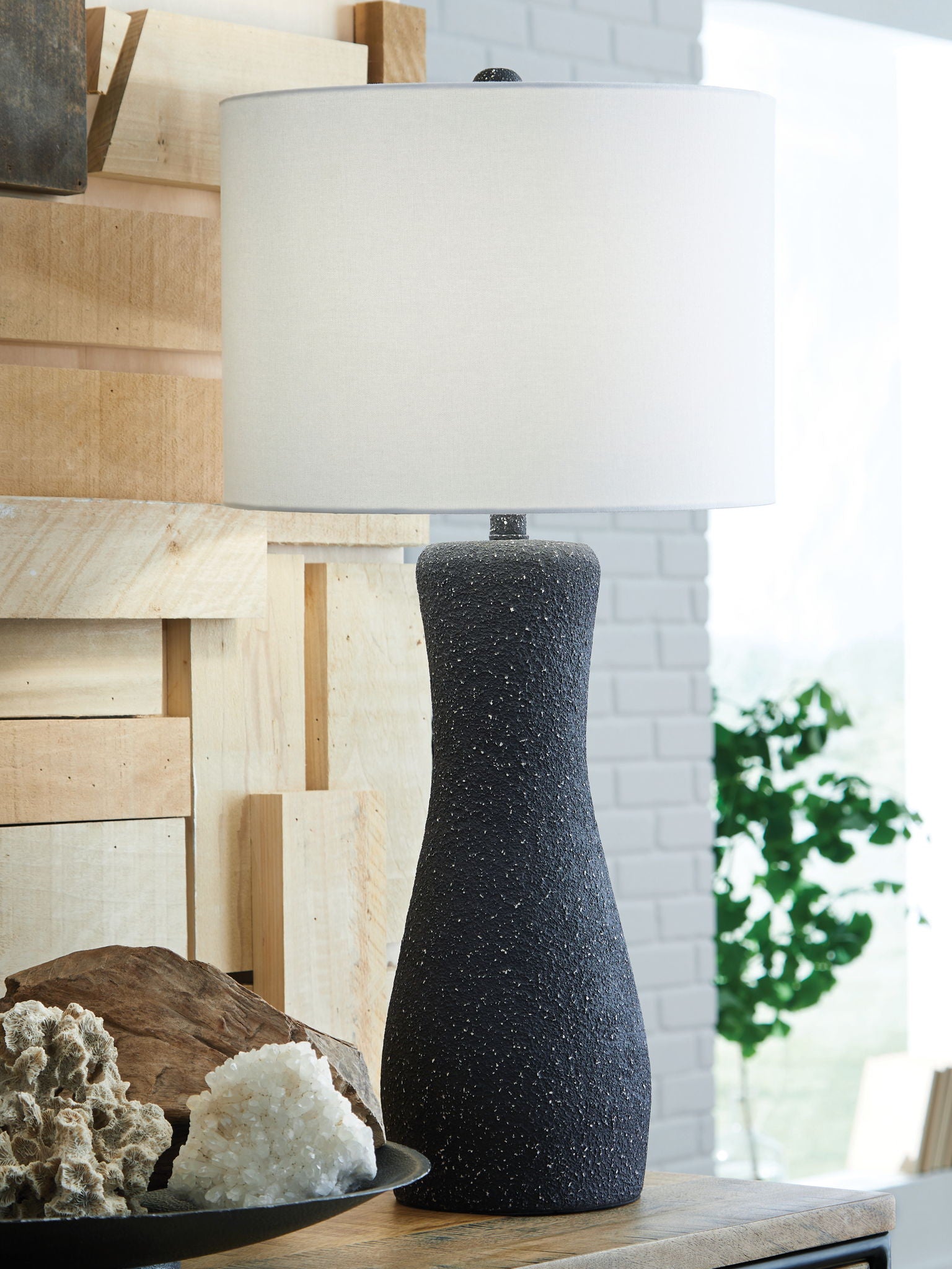 Black speckled metal table lamp with white drum shade, tapered base