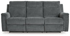 Power reclining sofa with three front seat sections, gravel gray fabric and padded armrests