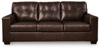 Dark brown leather sofa with tufted back and three cushioned seat sections