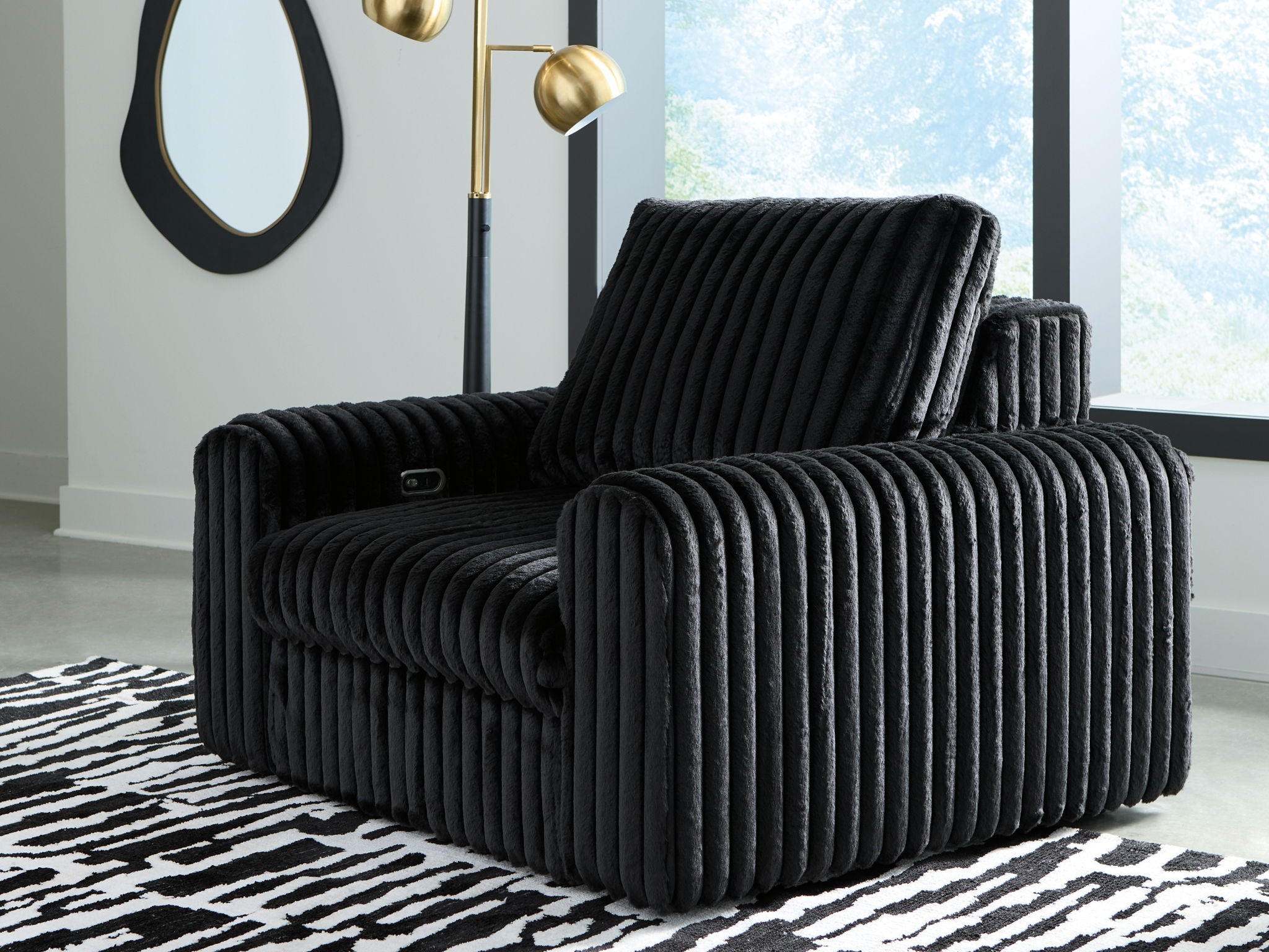 Onyx corduroy power gliding chaise with tufted seat, tall backrest, rounded arms.