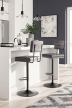 Set of 2 tall swivel barstools, dark gray fabric seats, round metal bases.