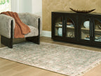 Rossbury rug corner, green specks on light ground with short fringed border
