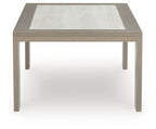Beige square coffee table with inset light top and straight legs