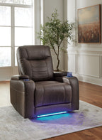 Slate gray power recliner with adjustable headrest and padded armrests, angled view