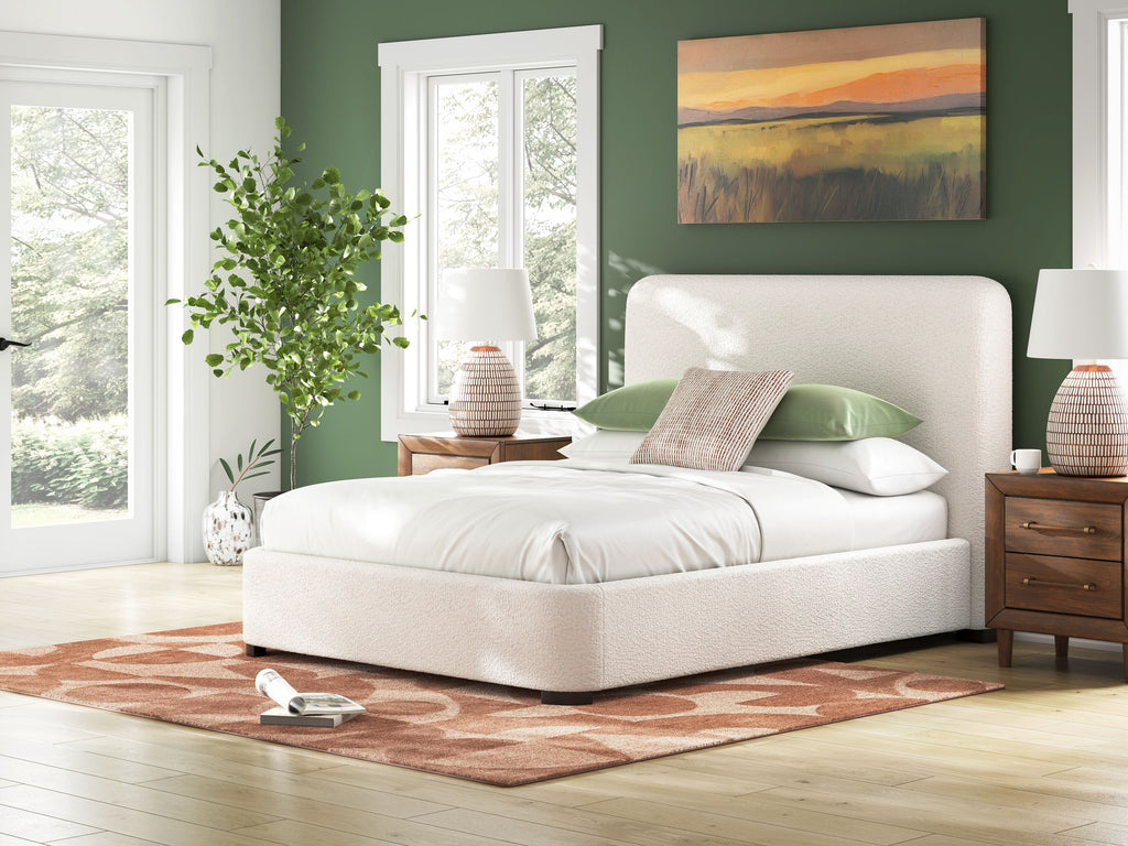 Beige upholstered bed with tall headboard and thick padded mattress frame